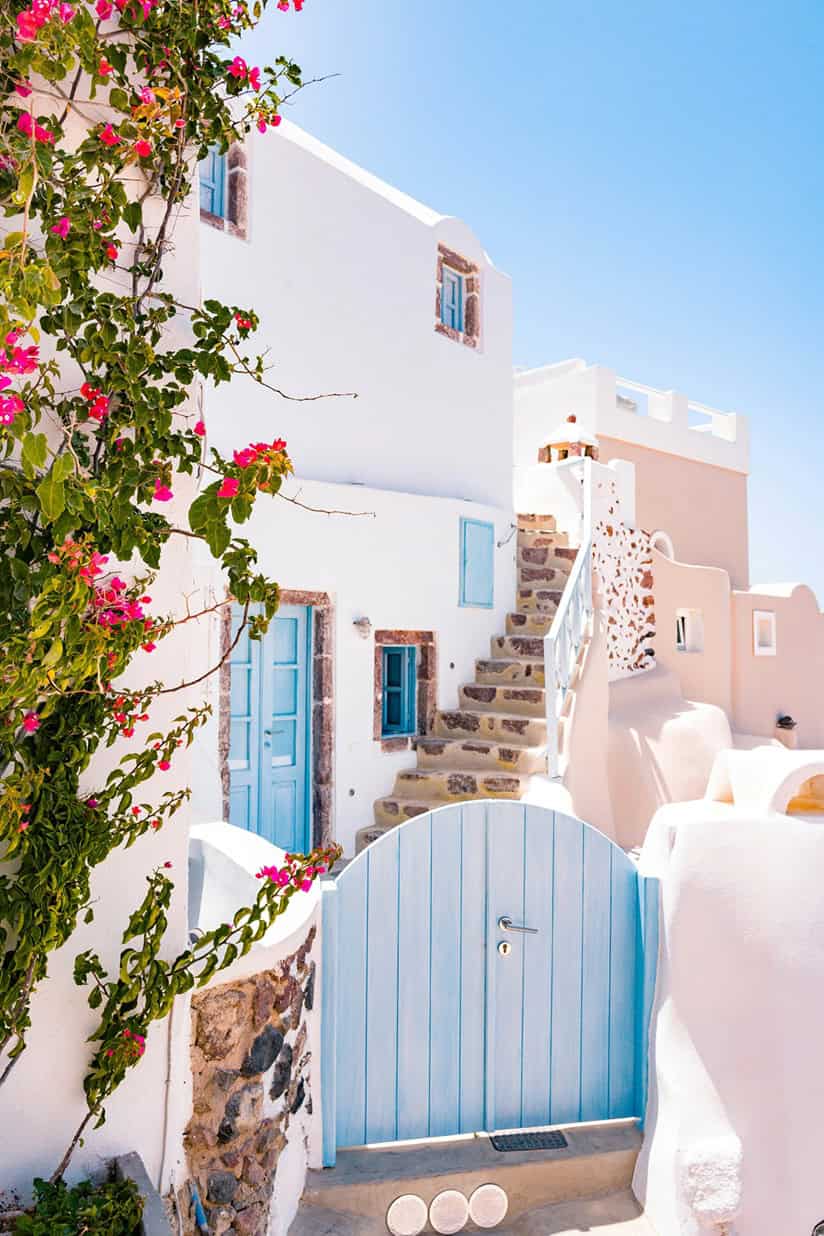 A building with the quintessential blue door in Oia, Greece.